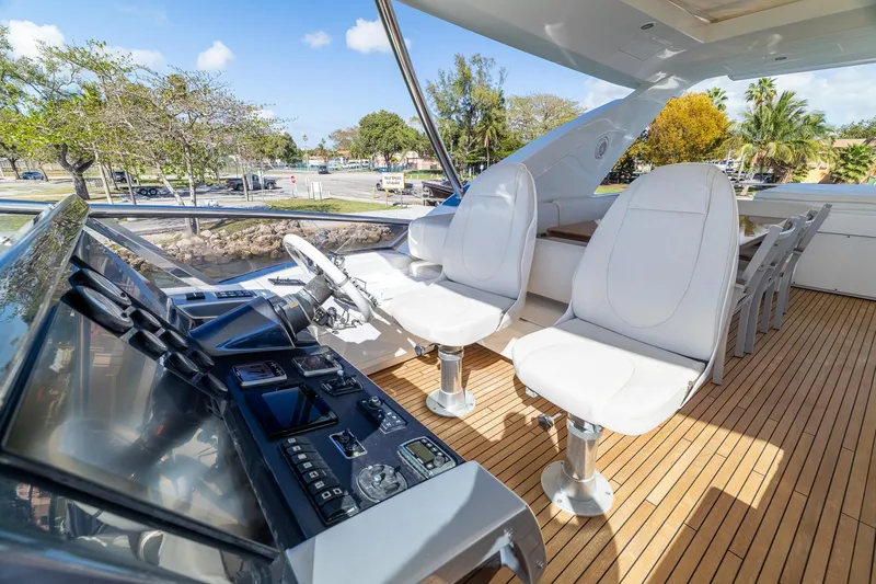 Slide: The Image of Luxurious 2015 Azimut 80 yacht helm with white seating and wooden deck. - 77