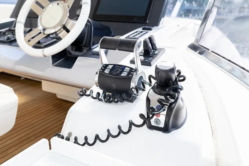 Slide: The Image of Control panel of a 2015 Azimut 80 yacht with steering wheel and throttle. - 81