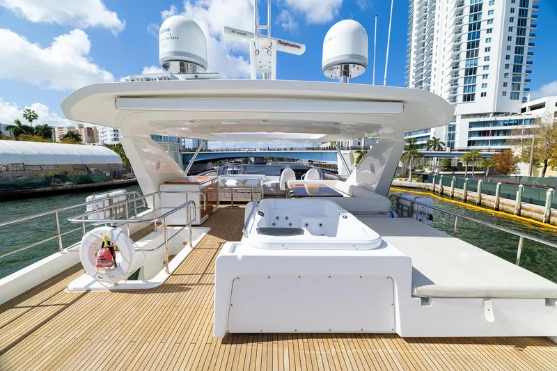 Slide: The Image of Luxurious 2015 Azimut 80 yacht deck with jacuzzi, docked near modern buildings. - 83