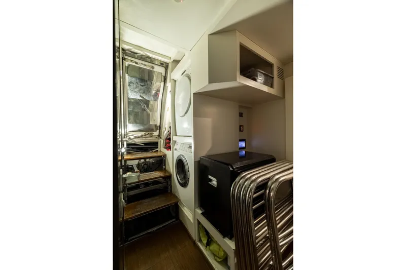 Slide: The Image of Laundry area inside 2015 Azimut 80 yacht with stacked washer and dryer. - 92