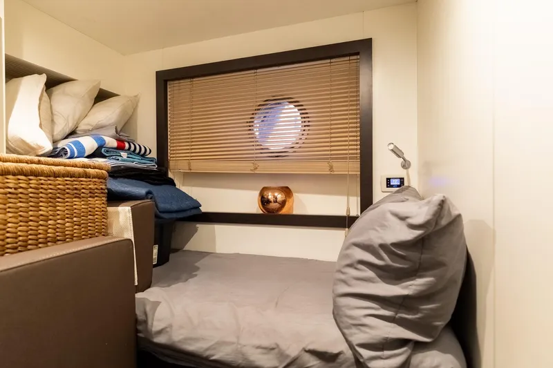 Slide: The Image of Cozy cabin interior of 2015 Azimut 80 yacht with bed, window, and storage. - 94