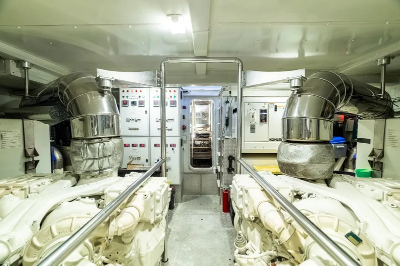 Slide: The Image of Engine room of a 2015 Azimut 80 yacht, featuring dual engines and control panels. - 97