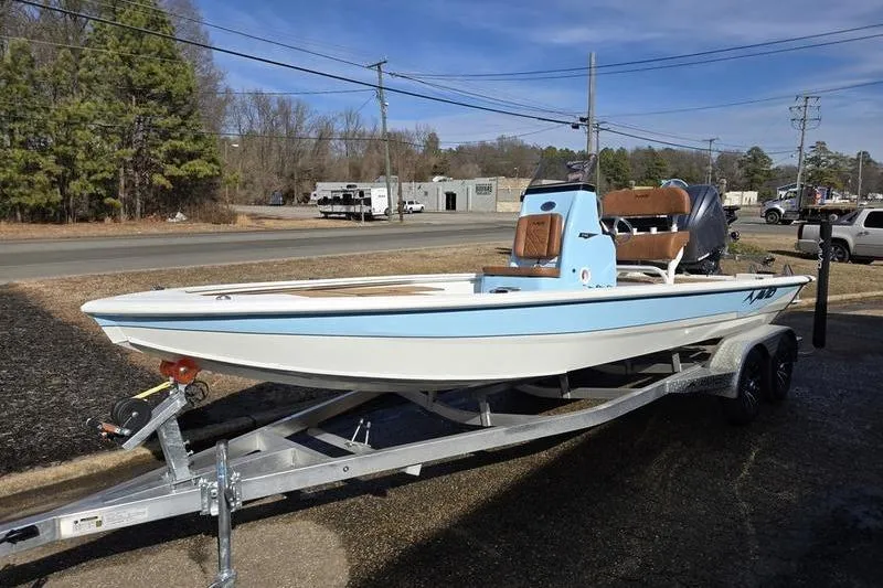 The Image of 2026 Avid 21 FSX boat on trailer, light blue and white, parked outdoors. - 0