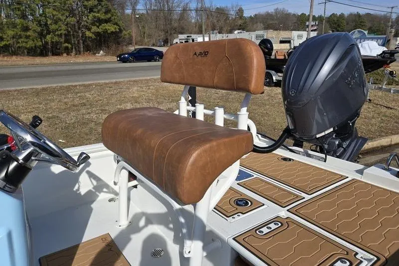 Slide: The Image of 2026 Avid 21 FSX boat with brown seating and powerful outboard motor. - 13