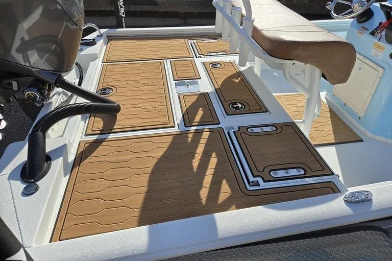 Slide: The Image of 2026 Avid 21 FSX boat deck with tan non-slip flooring and seating. - 3