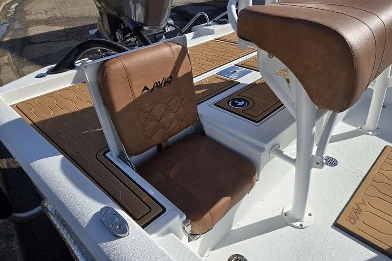Slide: The Image of 2026 Avid 21 FSX boat interior with brown leather seating and modern design. - 4