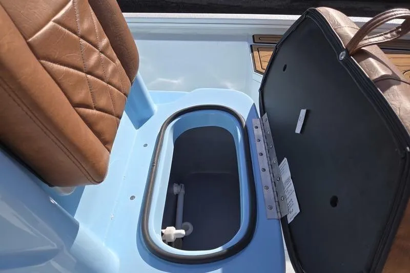 Slide: The Image of Open storage compartment in 2026 Avid 21 FSX boat with brown leather seat. - 6