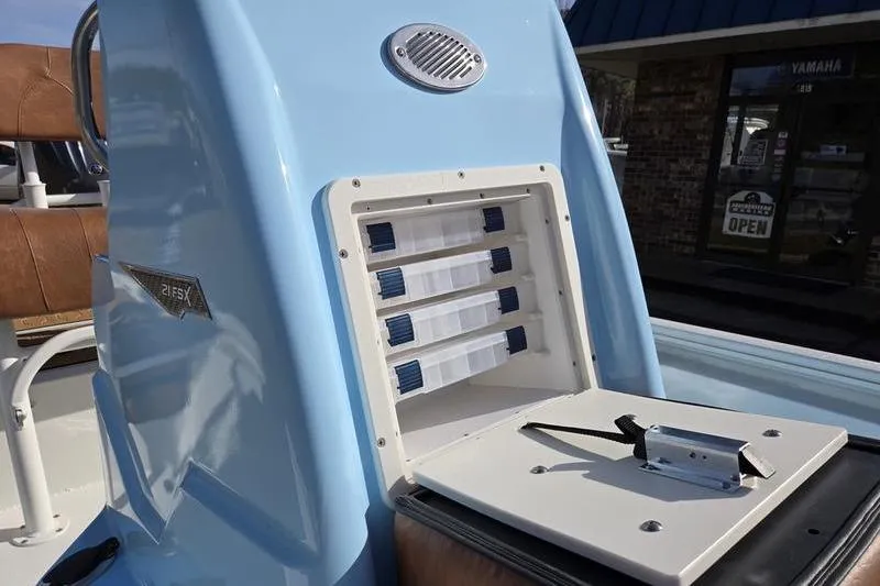 Slide: The Image of 2026 Avid 21 FSX boat console with storage compartments and sleek design. - 7