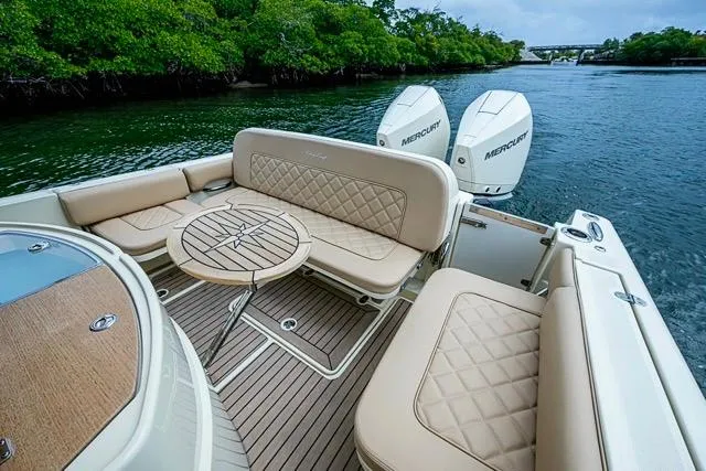 Slide: The Image of 2019 Chris-Craft Catalina 30 boat with luxurious seating and twin Mercury engines. - 13