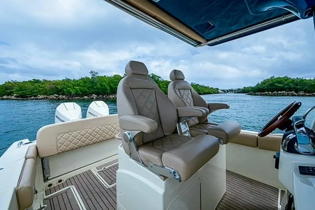 Slide: The Image of 2019 Chris-Craft Catalina 30 boat interior with luxurious seating and scenic water view. - 18