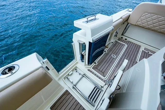 Slide: The Image of 2019 Chris-Craft Catalina 30 boat interior with elegant seating and teak flooring. - 21