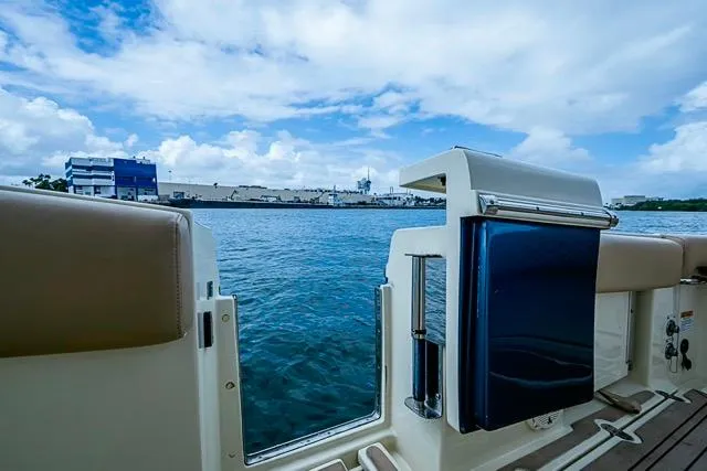 Slide: The Image of 2019 Chris-Craft Catalina 30 boat with open deck view, overlooking calm waters and blue sky. - 22