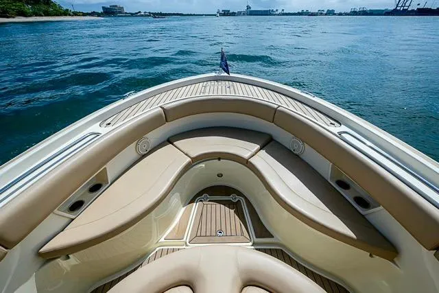 Slide: The Image of 2019 Chris-Craft Catalina 30 boat interior with tan seating, on calm water. - 31
