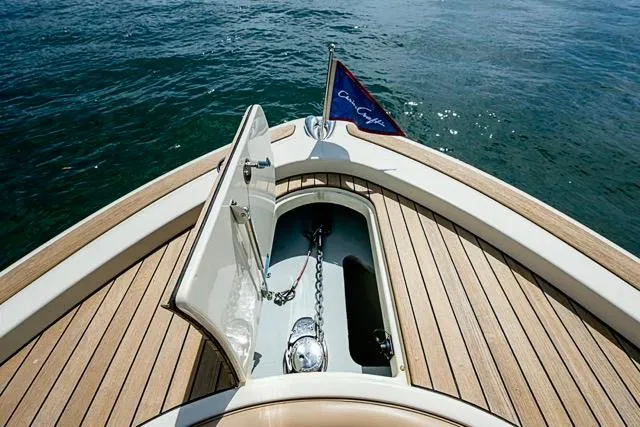 Slide: The Image of 2019 Chris-Craft Catalina 30 boat with open anchor hatch and flag on teak deck. - 32