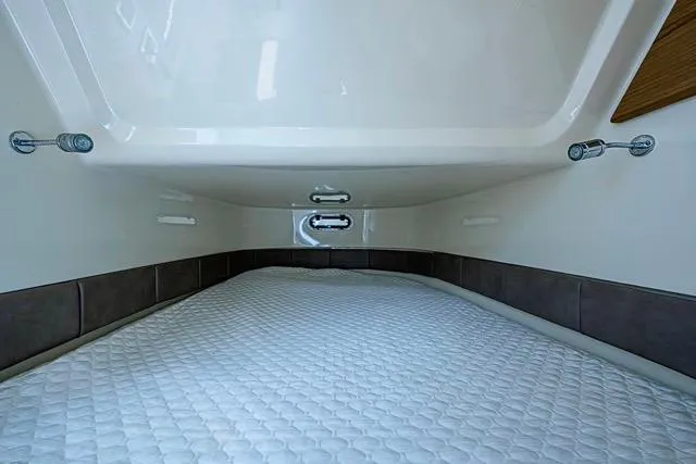 Slide: The Image of 2019 Chris-Craft Catalina 30 cabin interior with a comfortable sleeping area. - 34