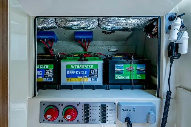 Slide: The Image of Battery compartment of 2019 Chris-Craft Catalina 30 with Interstate deep cycle batteries and Garmin equipment. - 35