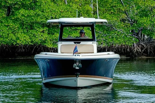 Slide: The Image of 2019 Chris-Craft Catalina 30 boat cruising in lush, green waters. - 38