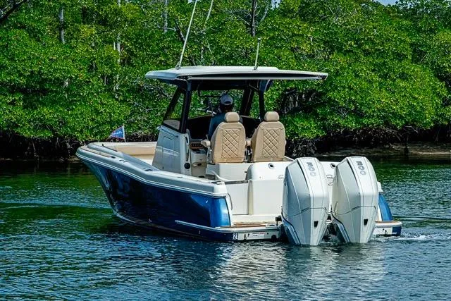 Slide: The Image of 2019 Chris-Craft Catalina 30 boat with dual engines cruising on a calm waterway. - 43