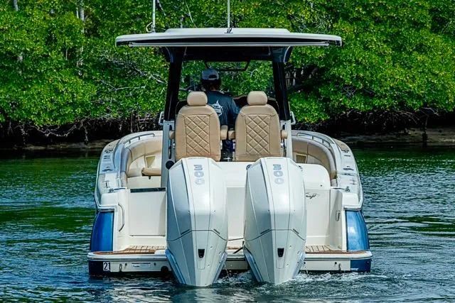 Slide: The Image of 2019 Chris-Craft Catalina 30 boat with dual engines on a calm waterway. - 5