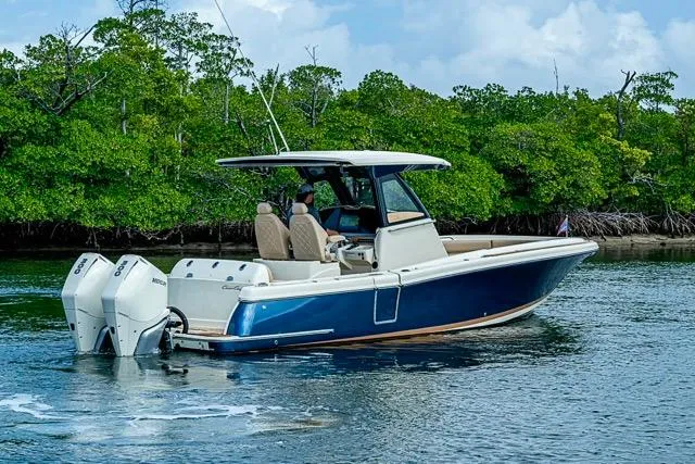 Slide: The Image of 2019 Chris-Craft Catalina 30 boat cruising near lush green mangroves. - 6