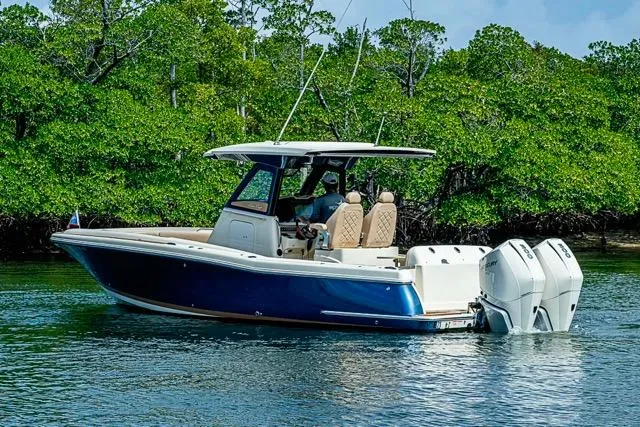 Slide: The Image of 2019 Chris-Craft Catalina 30 boat cruising near lush green mangroves. - 7