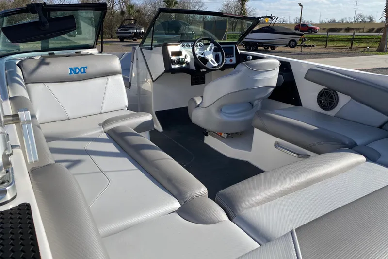 Slide: The Image of 2017 MASTERCRFAT NXT 20 boat interior with gray seating and modern dashboard. - 10