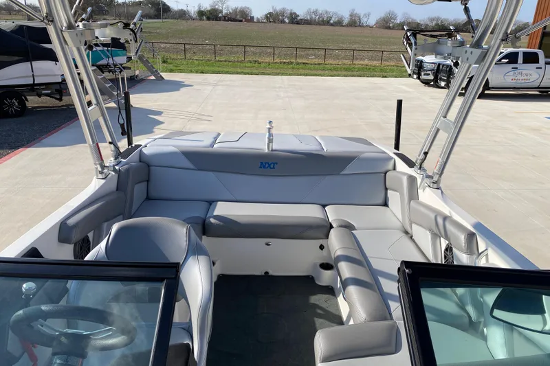 Slide: The Image of 2017 MASTERCRFAT NXT 20 boat interior with gray seating and open deck view. - 16