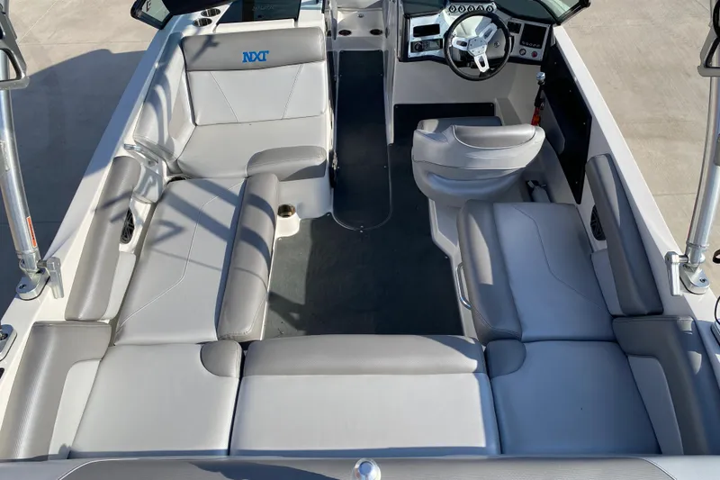 Slide: The Image of 2017 MASTERCRFAT NXT 20 boat interior with gray seating and modern dashboard. - 9