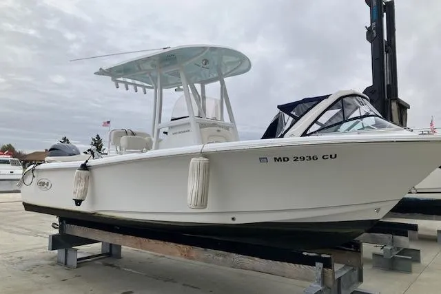 Slide: The Image of 2024 Sea Hunt Ultra 219 boat on a dock, featuring sleek design and modern amenities. - 2