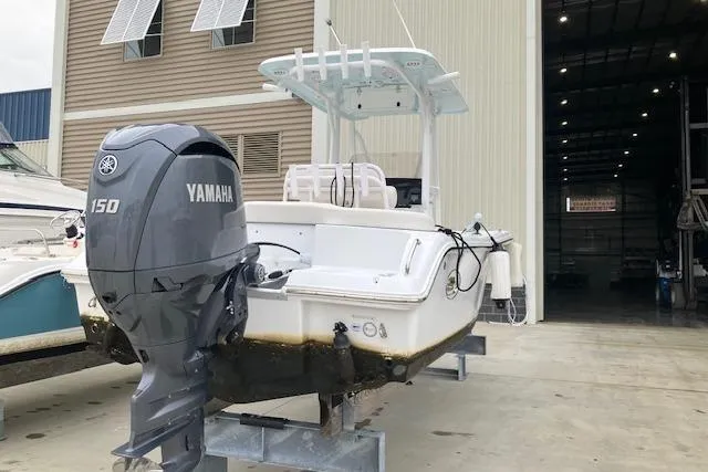 Slide: The Image of 2024 Sea Hunt Ultra 219 boat with Yamaha 150 engine in a marina. - 3