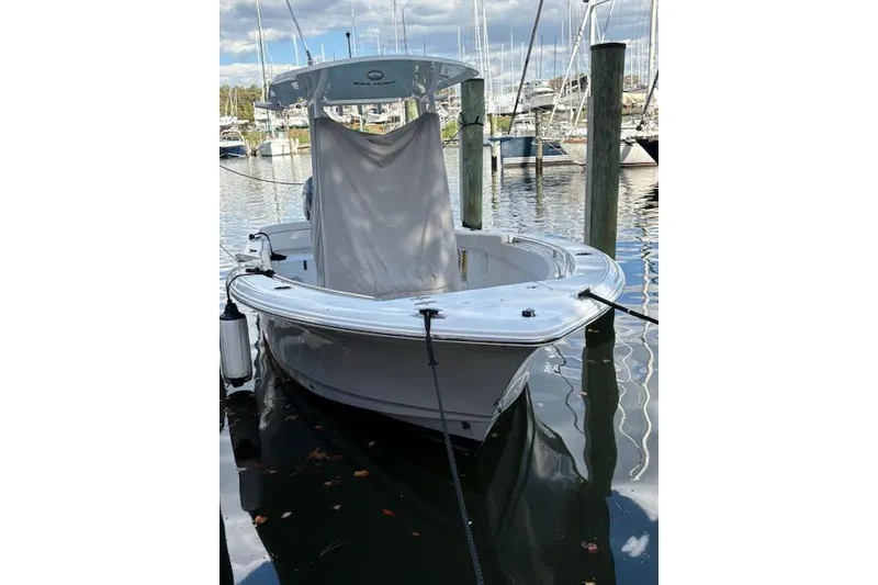 Slide: The Image of 2024 Sea Hunt Ultra 219 boat docked in a marina, front view. - 9
