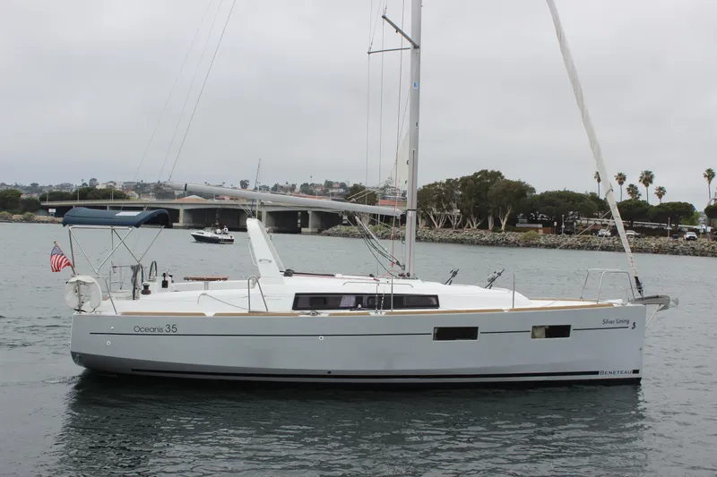 Slide: The Image of 2015 Beneteau Oceanis 35 sailboat on calm water, named "Silver Lining." - 3