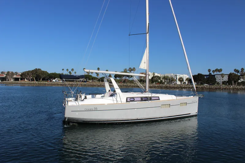 Slide: The Image of 2015 Beneteau Oceanis 35 sailboat on calm water under clear blue sky. - 6
