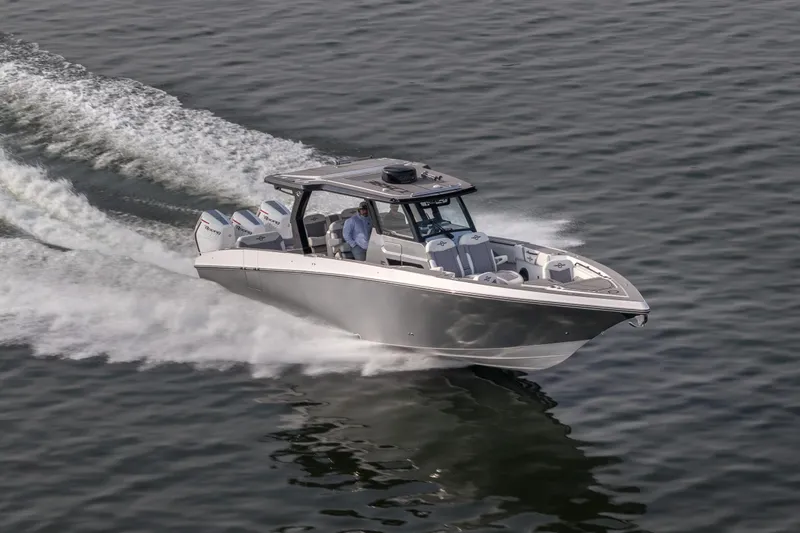 The Image of 2026 Fountain 38 SCX speedboat cruising on open water, showcasing sleek design and powerful engines. - 0