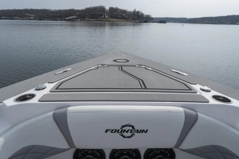 Slide: The Image of 2026 Fountain 38 SCX boat on calm lake, showcasing sleek design and spacious deck. - 10