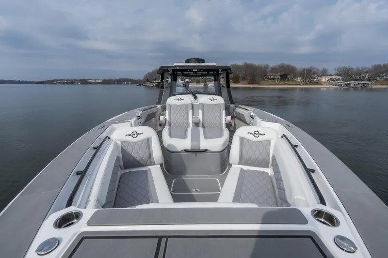 Slide: The Image of 2026 Fountain 38 SCX boat with luxurious seating on a calm lake. - 11