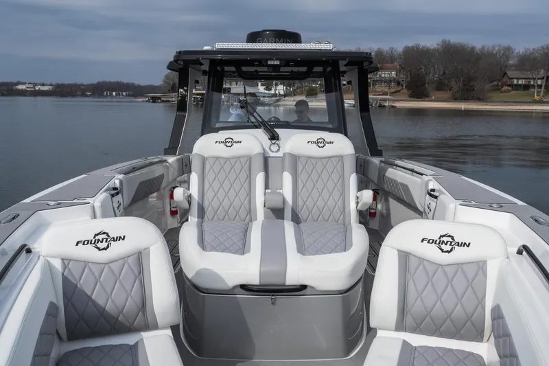 Slide: The Image of 2026 Fountain 38 SCX boat interior with luxurious seating on a calm lake. - 12