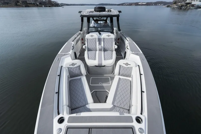 Slide: The Image of 2026 Fountain 38 SCX boat with luxurious seating on a calm lake. - 14