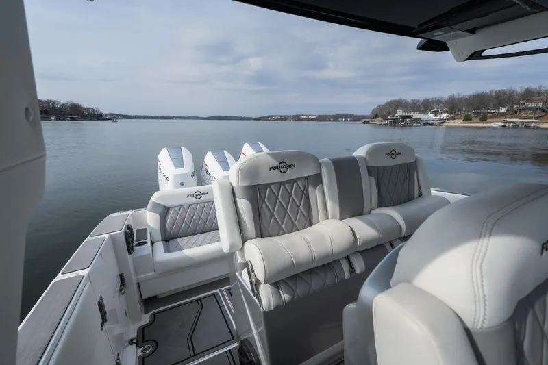 Slide: The Image of 2026 Fountain 38 SCX boat interior with luxurious seating on a calm lake. - 15