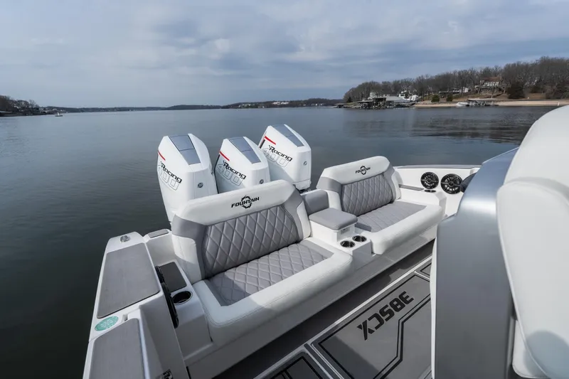 Slide: The Image of 2026 Fountain 38 SCX boat with luxurious seating and powerful engines on a serene lake. - 16