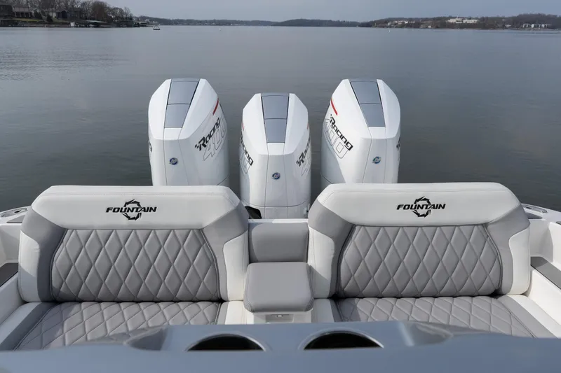 Slide: The Image of 2026 Fountain 38 SCX boat with triple outboard engines on a calm lake. - 19