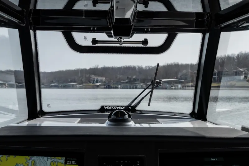 Slide: The Image of Interior view from a 2026 Fountain 38 SCX boat, overlooking a serene waterfront. - 22
