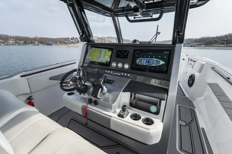 Slide: The Image of 2026 Fountain 38 SCX boat cockpit with advanced navigation system and luxurious seating. - 26