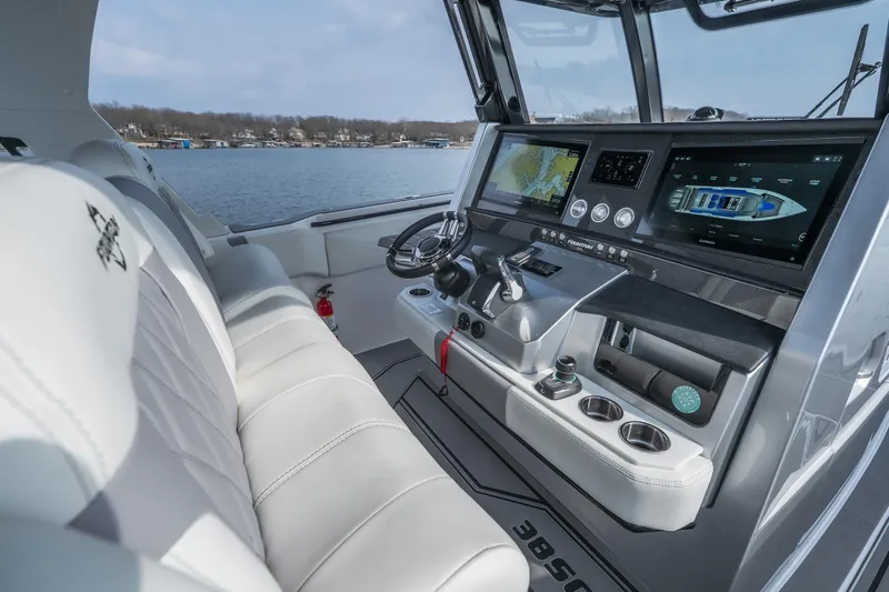 Slide: The Image of 2026 Fountain 38 SCX boat cockpit with advanced navigation displays and luxurious seating. - 27