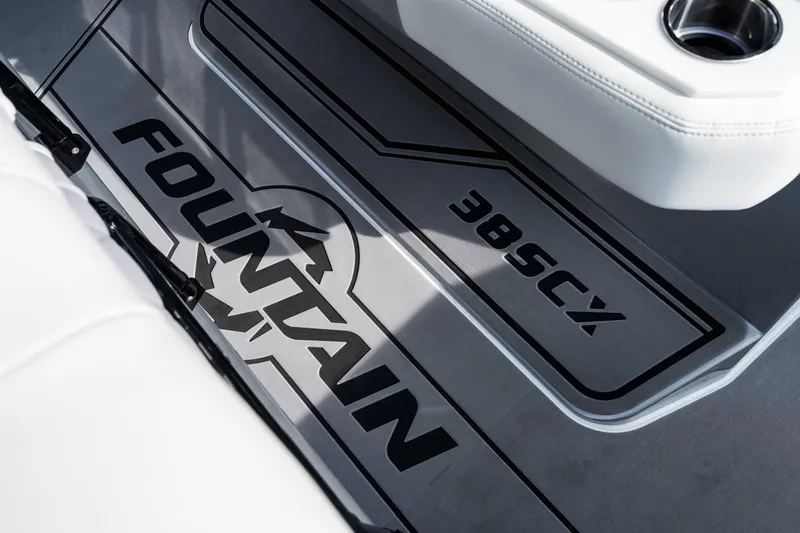 Slide: The Image of 2026 Fountain 38 SCX boat interior with logo and cup holder detail. - 28