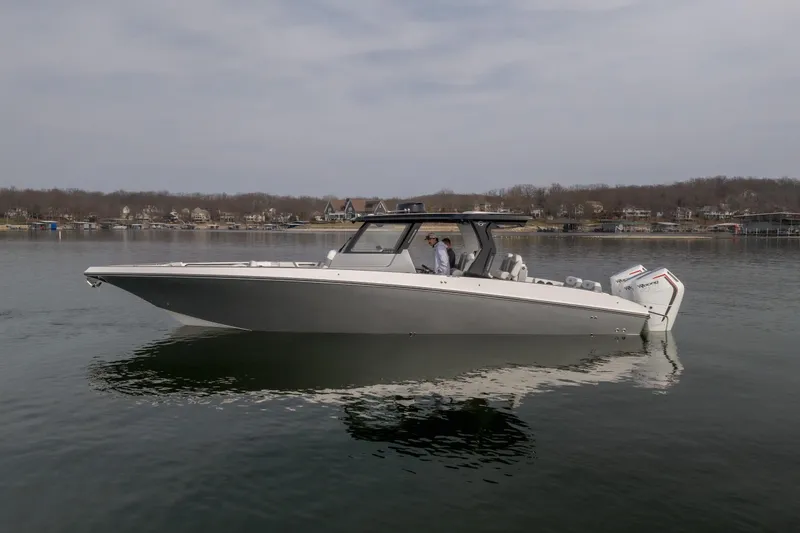 Slide: The Image of 2026 Fountain 38 SCX boat on calm lake with scenic background. - 3