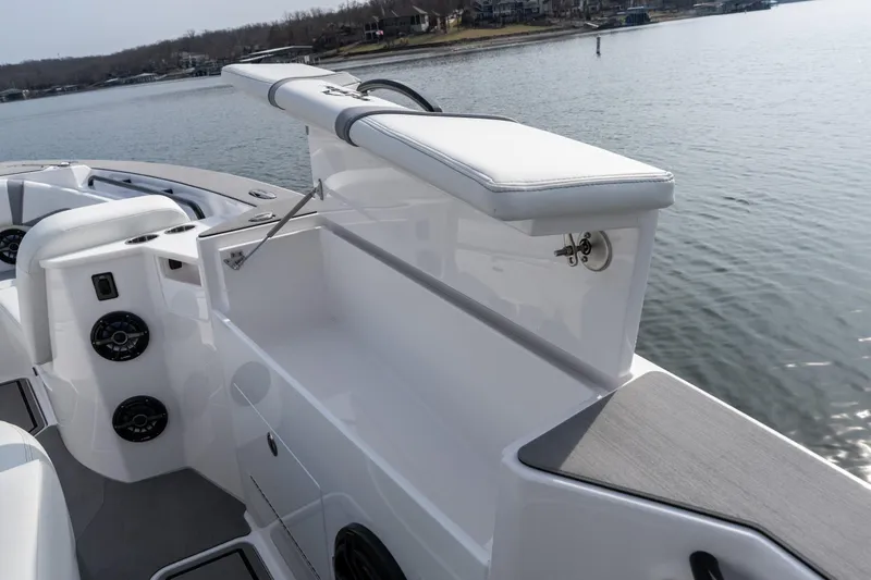 Slide: The Image of 2026 Fountain 38 SCX boat interior with seating and storage, on a calm lake. - 31