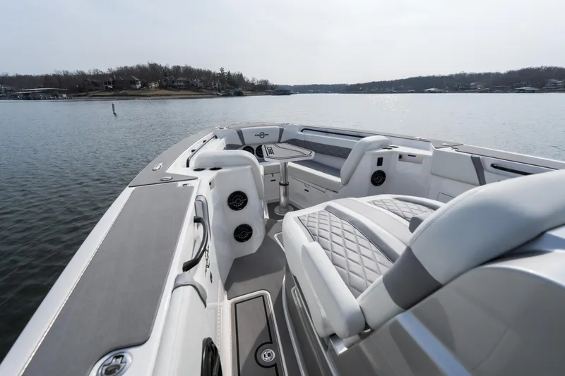 Slide: The Image of 2026 Fountain 38 SCX boat interior with luxurious seating on a calm lake. - 36