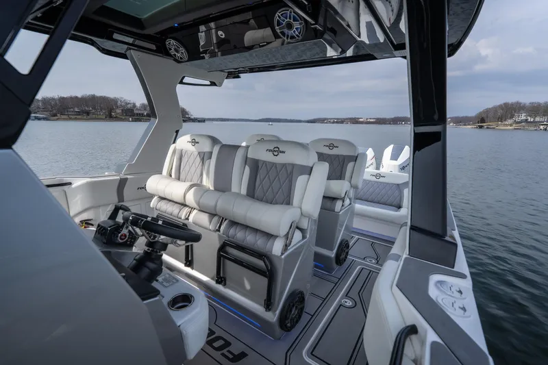 Slide: The Image of 2026 Fountain 38 SCX boat interior with luxurious seating on a calm lake. - 37