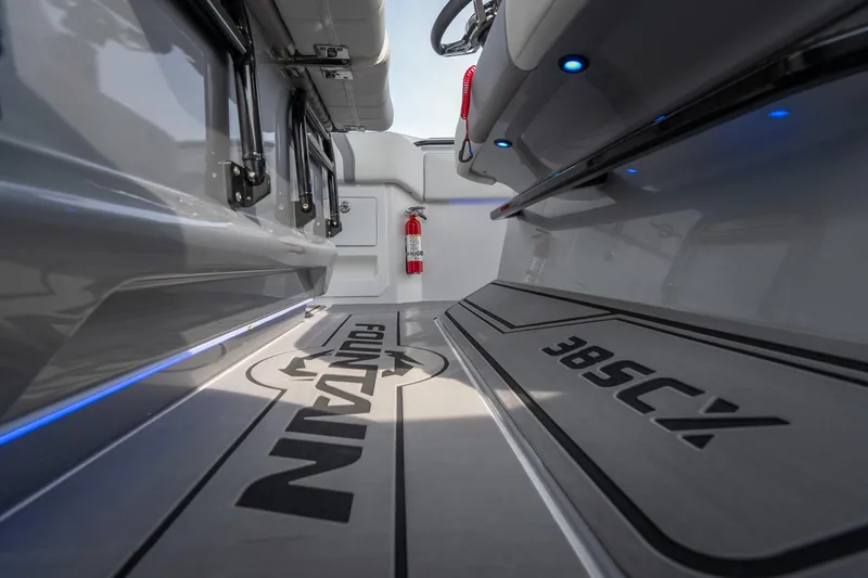Slide: The Image of 2026 Fountain 38 SCX boat interior with sleek design and ambient blue lighting. - 43